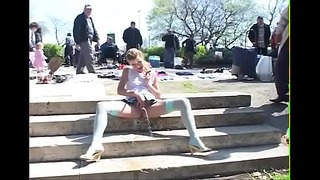 Young Blonde Peeing Among People At The Flea Market