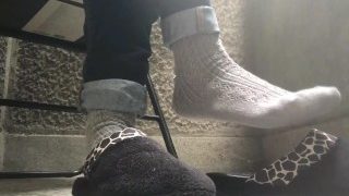 Grey Sweaty Socks In Slippers On A Balcony Trailer
