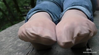 Jeans Feet In Nylon Socks In The Forest