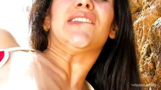 Fingering her tight pussy on the beach makes the busty